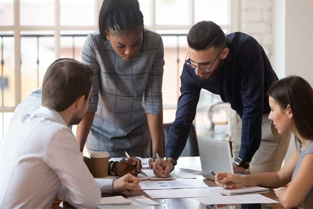 Business People Gathered Around A Table